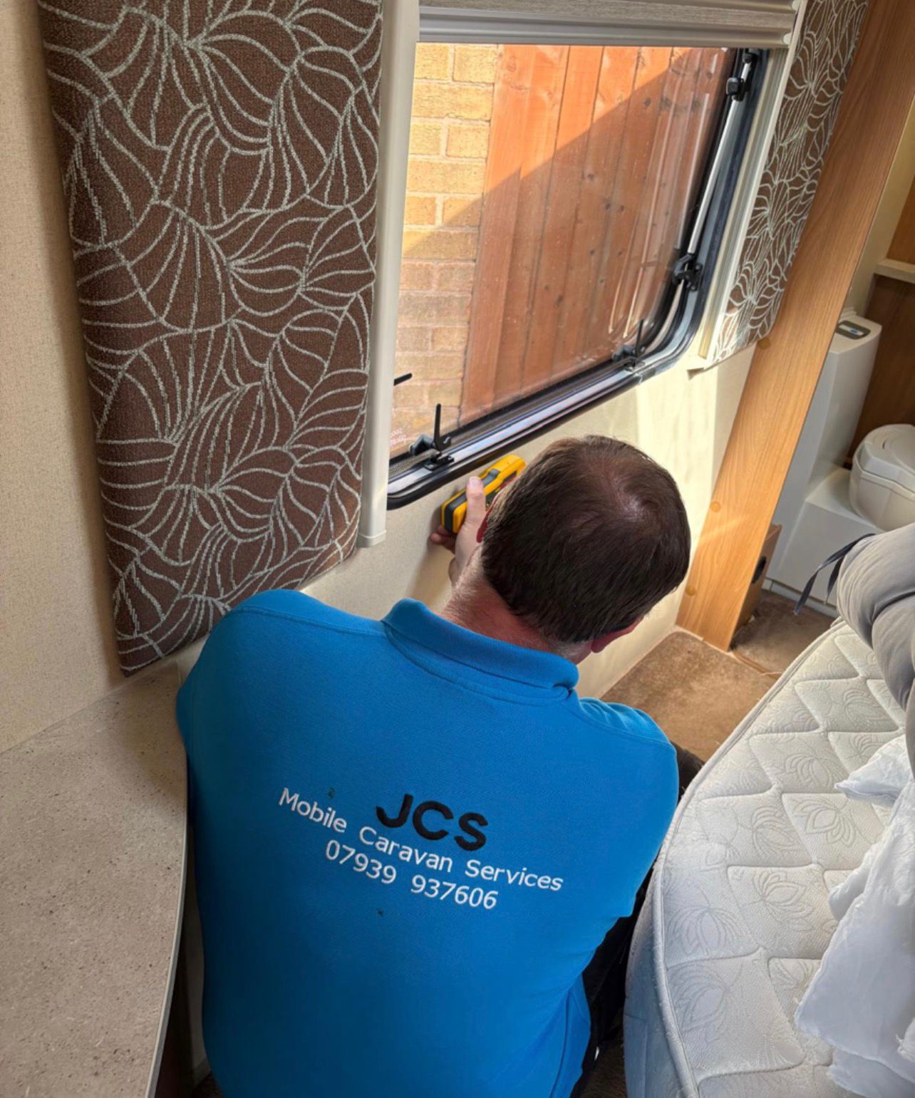 James carrying out caravan repairs and maintenance on site