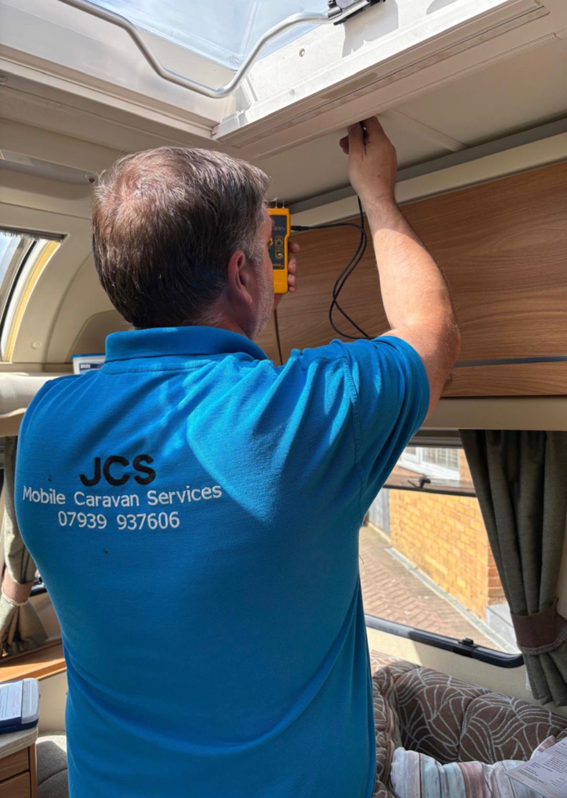 James carrying out caravan repairs and maintenance on site